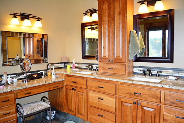 Mid-sized arts and crafts master bathroom in Boise with a freestanding tub, raised-panel cabinets, medium wood cabinets, gray tile, matchstick tile, granite benchtops, beige walls, slate floors, an undermount sink and multi-coloured floor.
