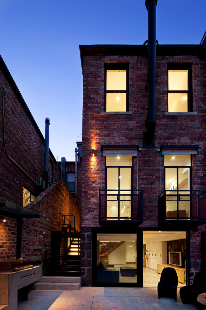 This is an example of a mid-sized traditional three-storey brick red exterior in Melbourne.