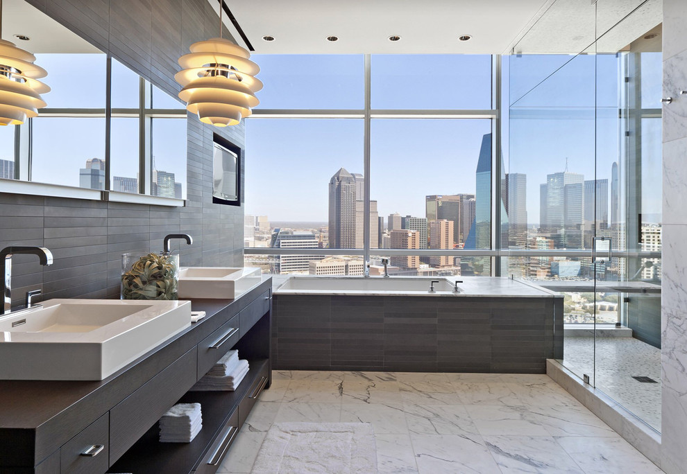Inspiration for a contemporary master bathroom in Other with flat-panel cabinets, grey cabinets, an undermount tub, gray tile, a vessel sink, white floor and a hinged shower door.