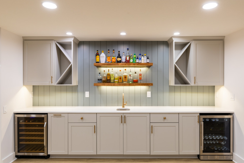 Inspiration for a large traditional fully buried basement in Kansas City with a home bar, vinyl flooring and tongue and groove walls.