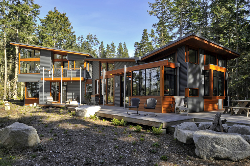 Design ideas for a contemporary exterior in Seattle with wood siding and a butterfly roof.