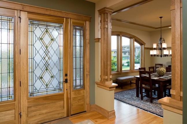 Inspiration for a large arts and crafts foyer in Chicago with multi-coloured walls, medium hardwood floors, a single front door and a light wood front door.