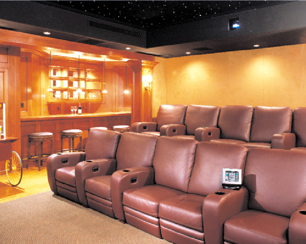 Photo of a large contemporary enclosed home theatre in Philadelphia with yellow walls, carpet, a projector screen and beige floor.