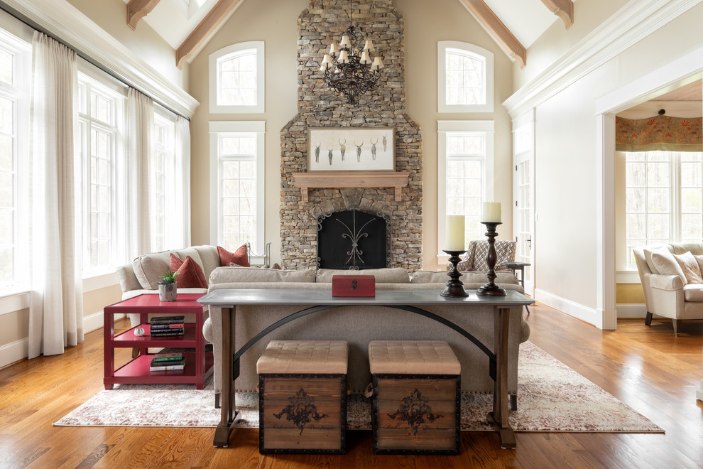 Family room - transitional open concept medium tone wood floor and brown floor family room idea in Richmond with beige walls, a standard fireplace, a stone fireplace and no tv