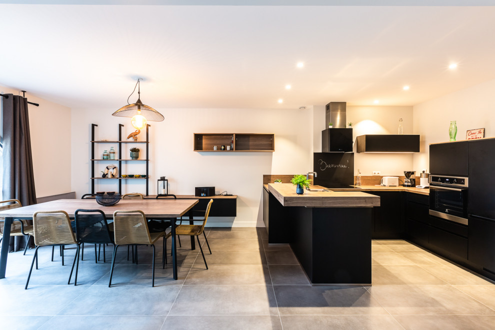 Design ideas for a mid-sized modern u-shaped open plan kitchen in Other with a drop-in sink, wood benchtops, brown splashback, timber splashback, panelled appliances, no island, grey floor and brown benchtop.