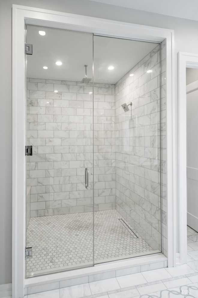 Large industrial master bathroom in Chicago with recessed-panel cabinets, white cabinets, an alcove shower, a one-piece toilet, white tile, marble, grey walls, porcelain floors, an undermount sink, marble benchtops, white floor, a hinged shower door and white benchtops.