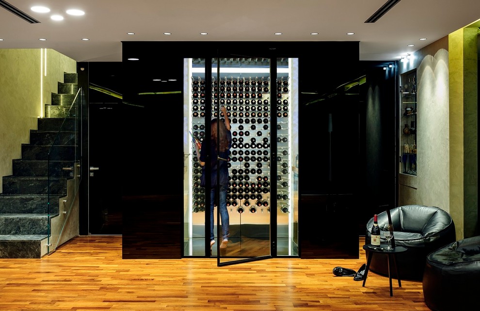 This is an example of a modern wine cellar in Orange County with display racks.