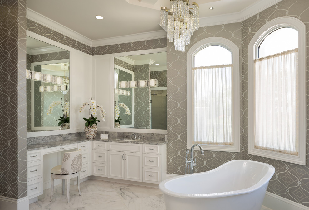Design ideas for a large mediterranean master bathroom in Miami with marble floors, quartzite benchtops, grey benchtops, recessed-panel cabinets, white cabinets, multi-coloured walls, an undermount sink and white floor.