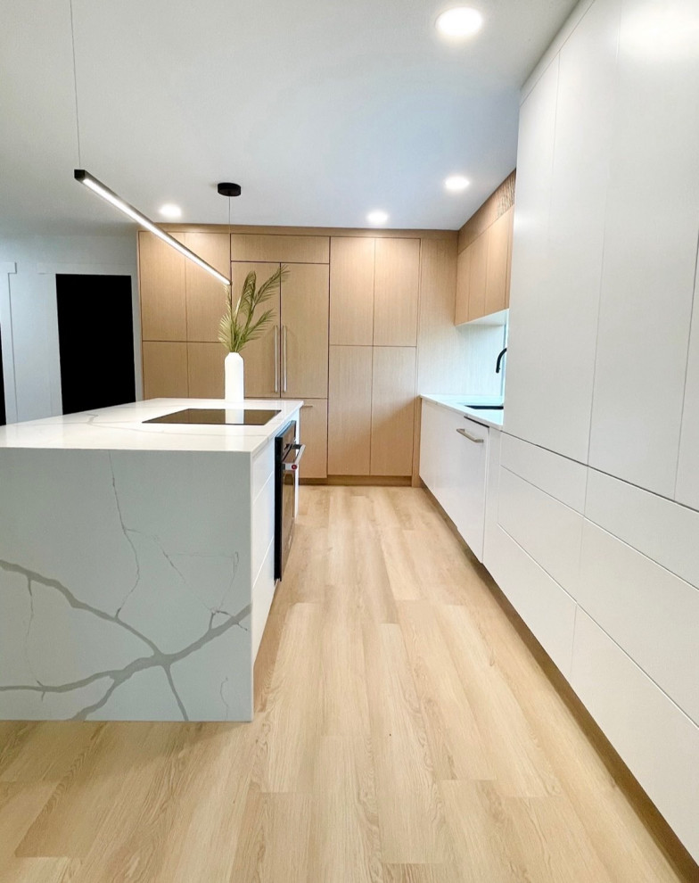 This is an example of a scandinavian eat-in kitchen in Other with an undermount sink, flat-panel cabinets, light wood cabinets, quartz benchtops, panelled appliances, vinyl floors, with island and white benchtop.