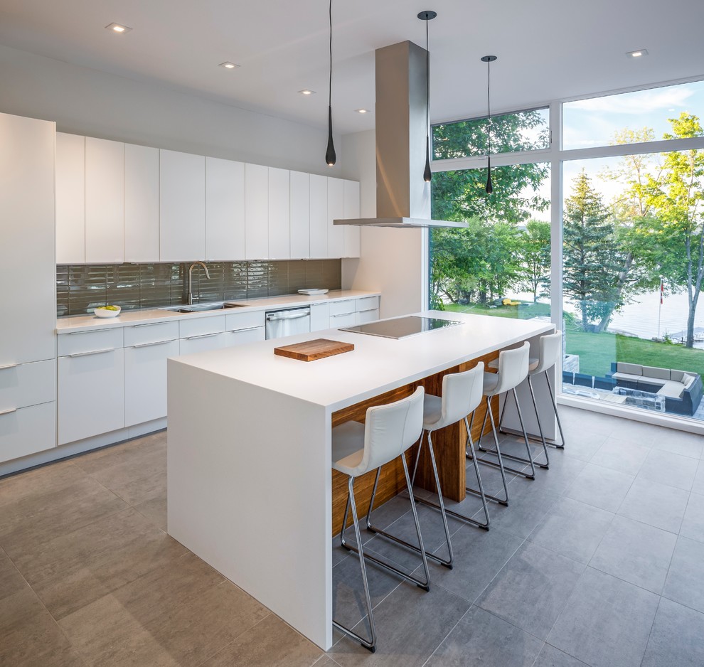 Design ideas for a mid-sized contemporary l-shaped open plan kitchen in Ottawa with an undermount sink, flat-panel cabinets, white cabinets, solid surface benchtops, grey splashback, glass tile splashback, stainless steel appliances, concrete floors and with island.