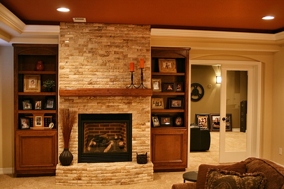 Photo of a large transitional look-out basement in Denver with beige walls, carpet, a standard fireplace and a stone fireplace surround.