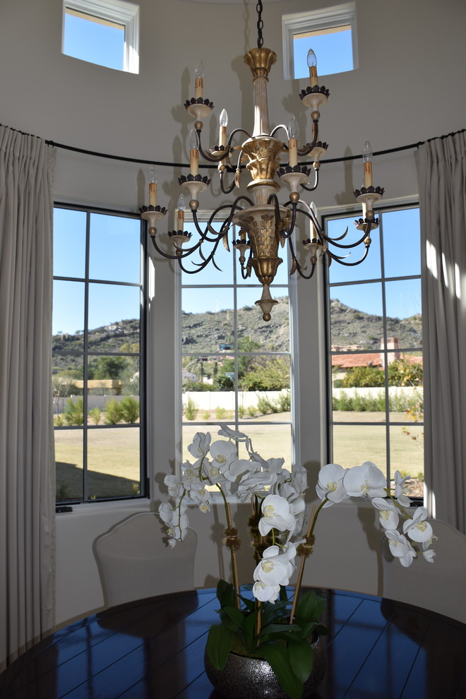 Example of a mid-sized tuscan travertine floor and beige floor kitchen/dining room combo design in Phoenix with white walls