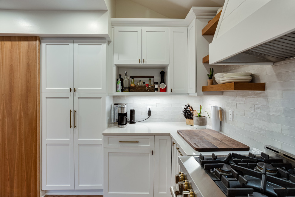 Design ideas for a large modern u-shaped kitchen/diner in DC Metro with recessed-panel cabinets, white cabinets, engineered stone countertops, white splashback, metro tiled splashback, stainless steel appliances and a breakfast bar.