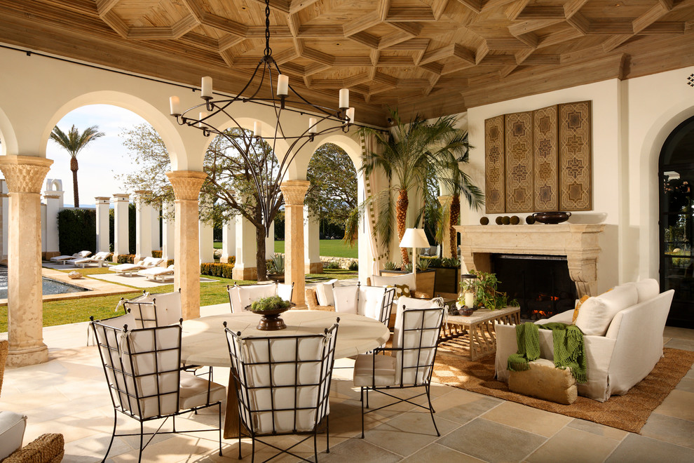 Mediterranean backyard patio in Los Angeles with with fireplace and tile.