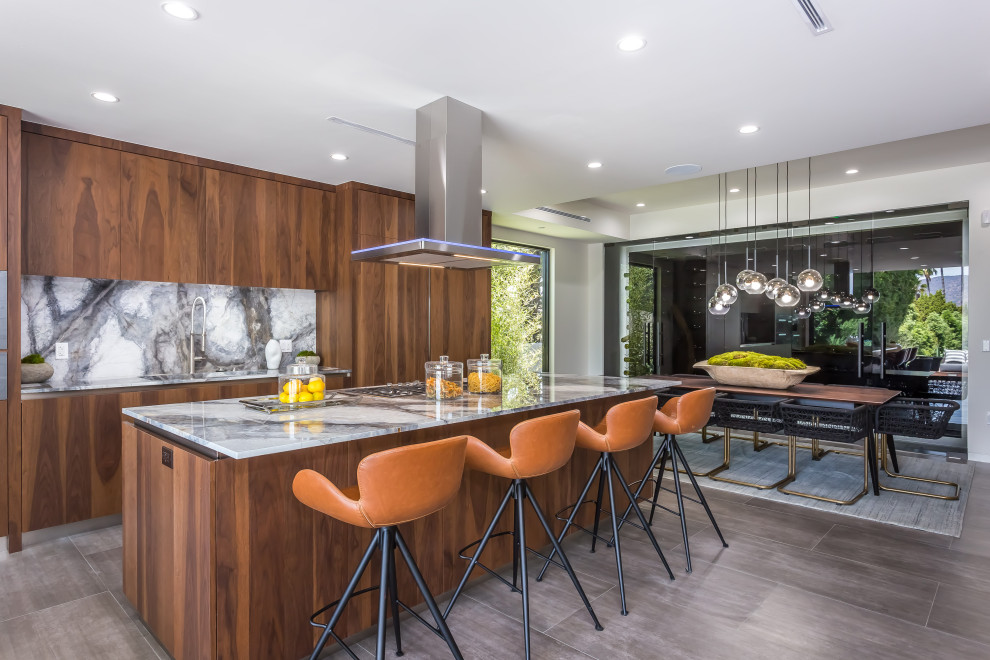Mid-sized contemporary u-shaped eat-in kitchen in Los Angeles with an undermount sink, flat-panel cabinets, dark wood cabinets, quartz benchtops, white splashback, stone slab splashback, stainless steel appliances, vinyl floors, with island, grey floor and white benchtop.