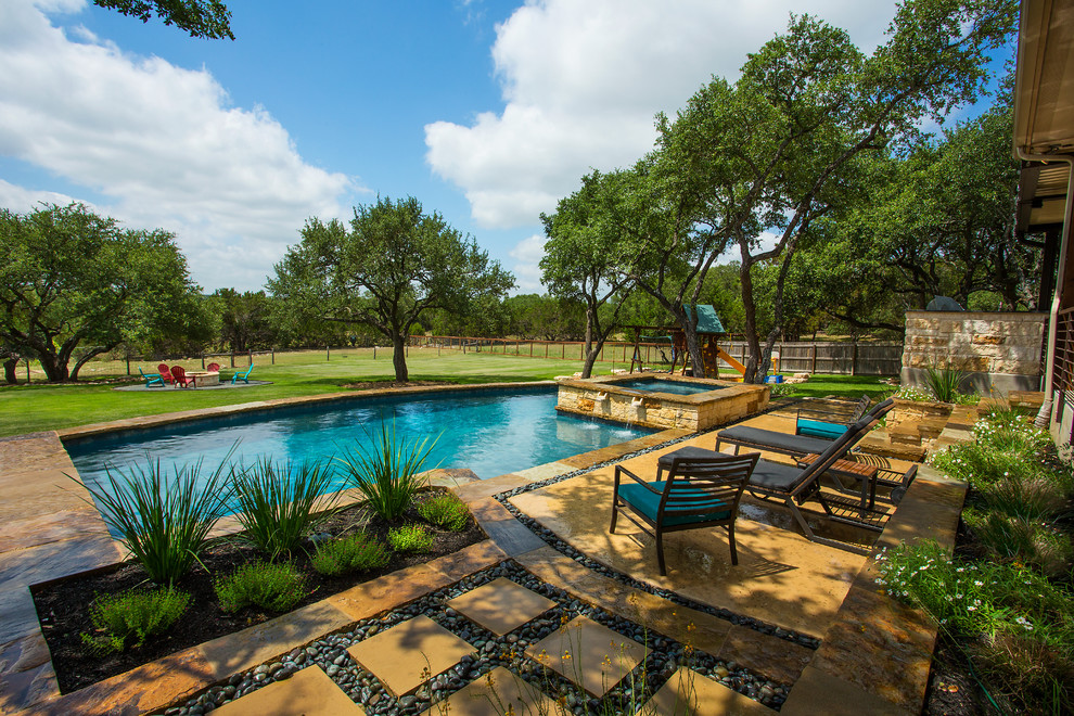 This is an example of a mid-sized traditional backyard custom-shaped lap pool in Austin with a water feature and concrete slab.
