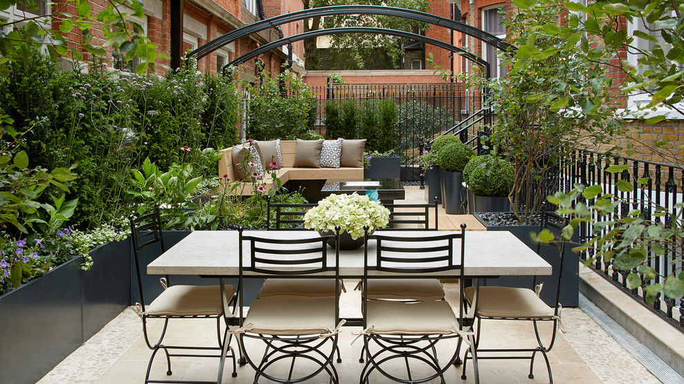 This is an example of a traditional courtyard patio in London with no cover.
