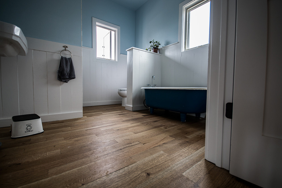 Country bathroom in Austin with medium hardwood floors.