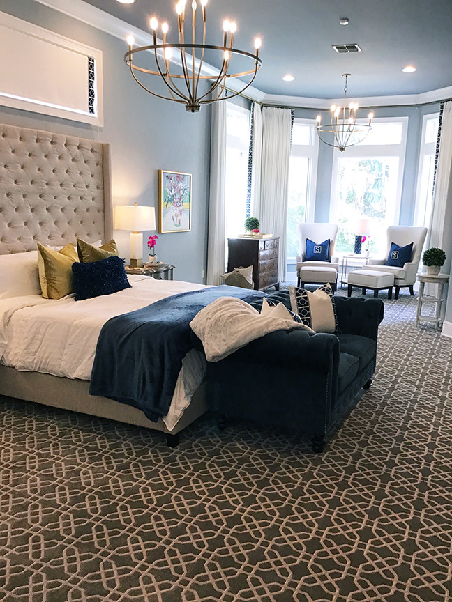 This is an example of a large transitional master bedroom in Orlando with blue walls, carpet and grey floor.