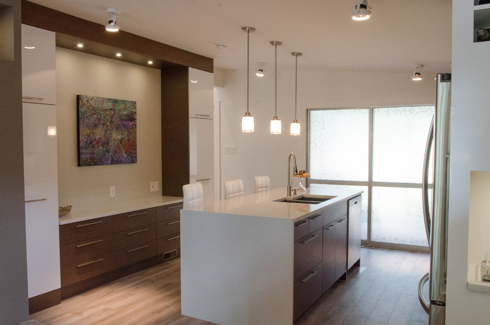 Eat-in kitchen - mid-sized modern u-shaped dark wood floor eat-in kitchen idea with a double-bowl sink, flat-panel cabinets, medium tone wood cabinets, quartzite countertops, white backsplash, mosaic tile backsplash, stainless steel appliances and an island