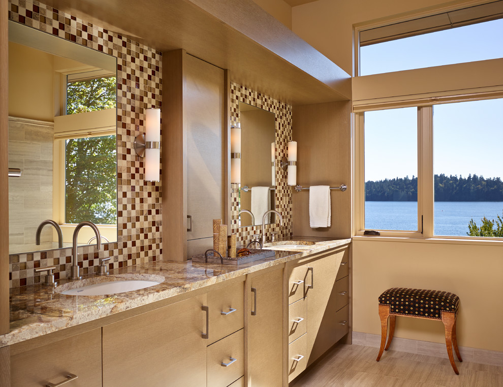 This is an example of a mid-sized contemporary master bathroom in Seattle with mosaic tile, flat-panel cabinets, beige cabinets, a two-piece toilet, beige tile, beige walls, porcelain floors, an undermount sink, granite benchtops, beige floor and beige benchtops.