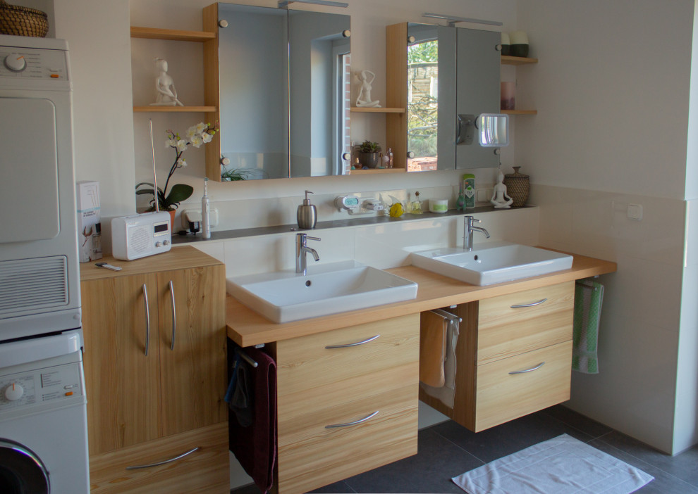 Photo of a small traditional 3/4 bathroom in Hanover with flat-panel cabinets, light wood cabinets, a single vanity and a floating vanity.