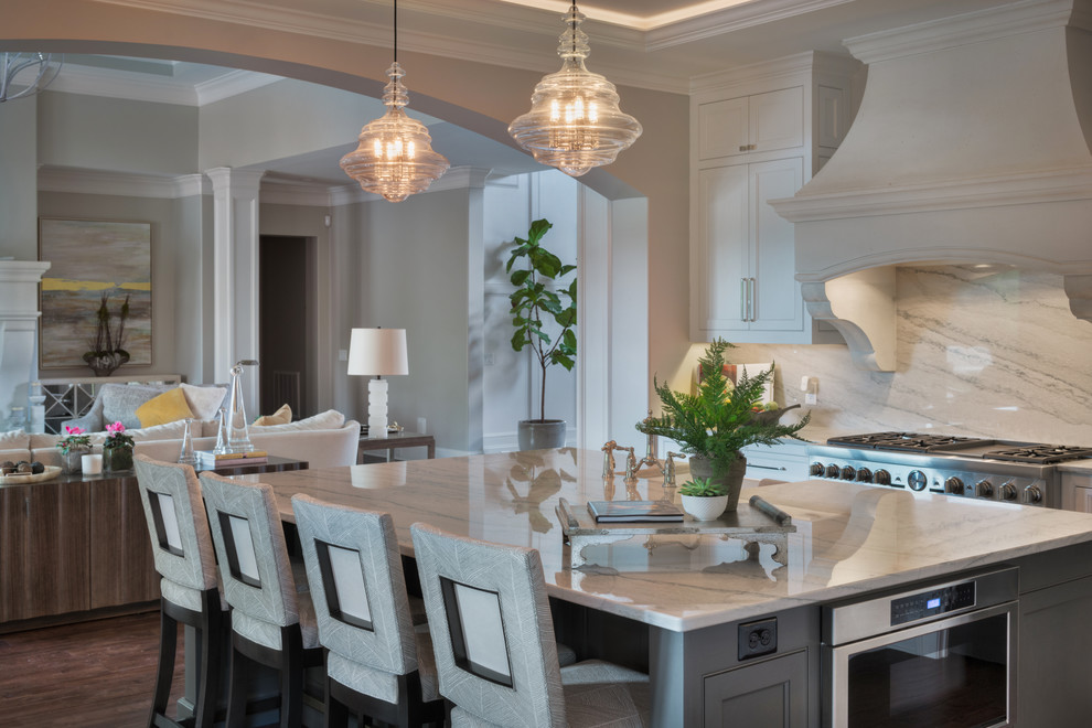 Inspiration for a large transitional u-shaped dark wood floor open concept kitchen remodel with an undermount sink, white cabinets, quartzite countertops, stone slab backsplash, stainless steel appliances and an island