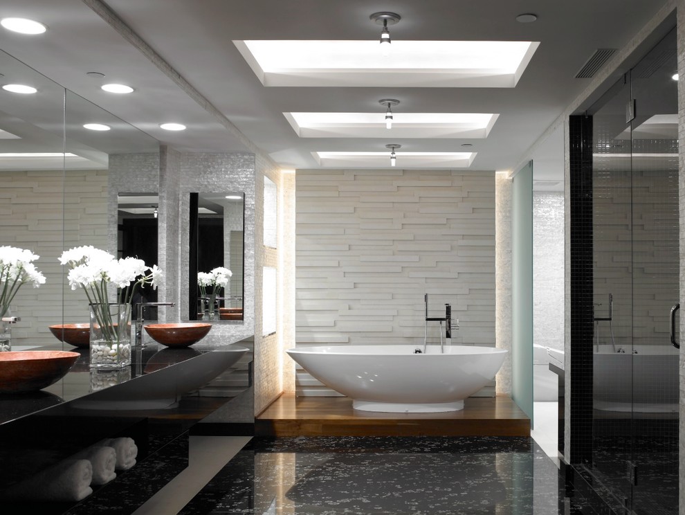 Photo of a large contemporary master bathroom in Miami with open cabinets, beige cabinets, a freestanding tub, an alcove shower, beige walls, medium hardwood floors and a vessel sink.
