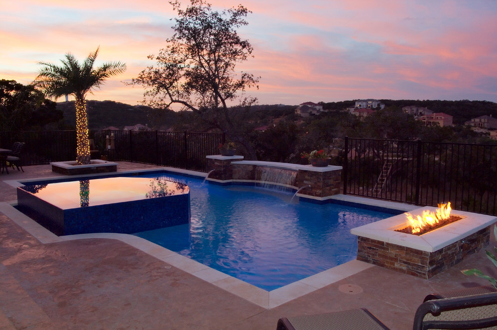 Photo of a mid-sized traditional backyard rectangular pool in Austin with a hot tub and concrete slab.