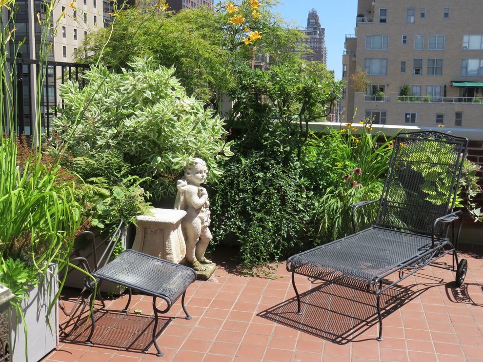 Photo of a mid-sized traditional courtyard patio in New York with a vertical garden, tile and no cover.