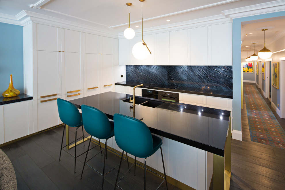 Design ideas for a contemporary l-shaped kitchen in Sydney with an undermount sink, flat-panel cabinets, white cabinets, black splashback, stone slab splashback, stainless steel appliances, dark hardwood floors, with island, brown floor and black benchtop.