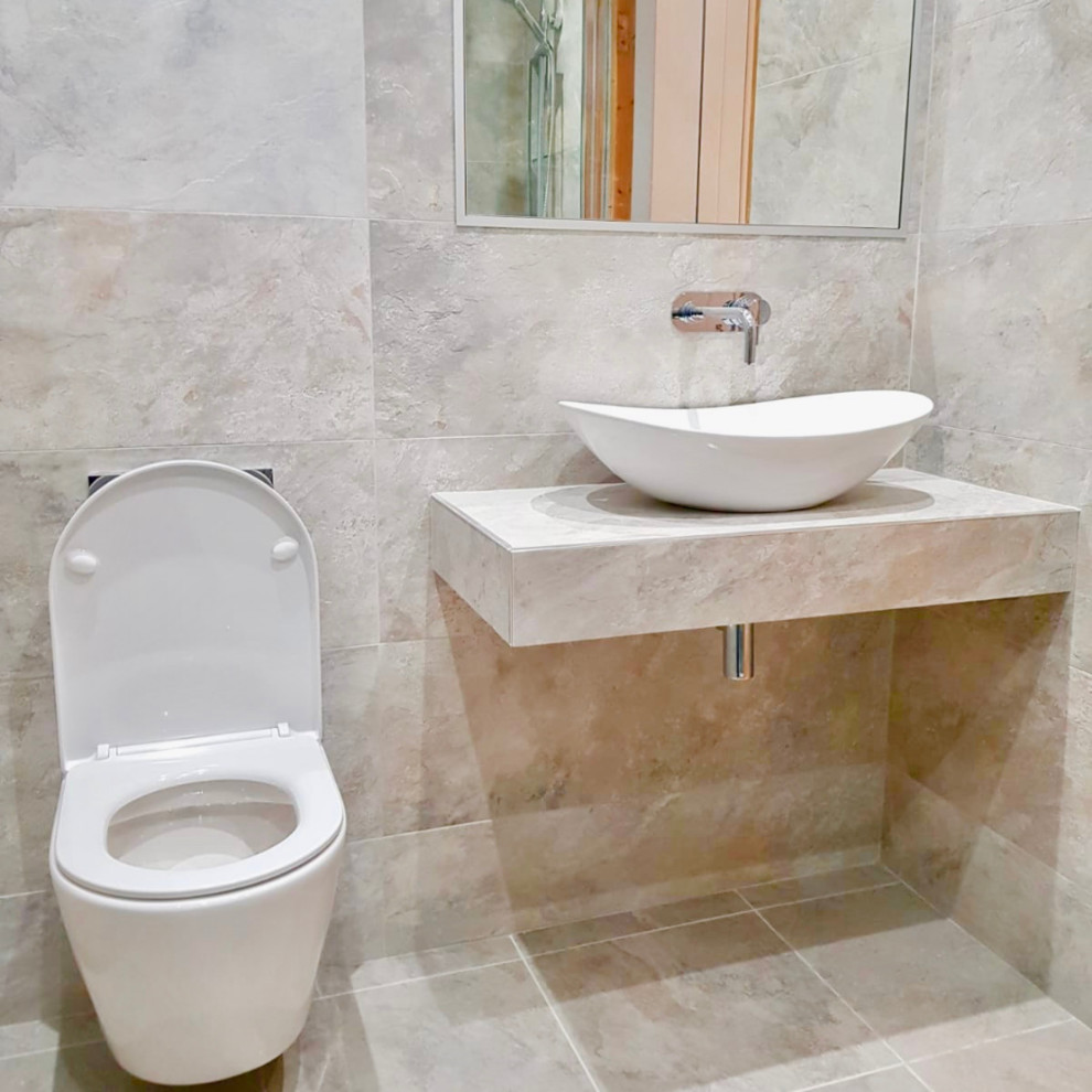 Design ideas for a mid-sized contemporary kids bathroom in Dublin with raised-panel cabinets, white cabinets, a corner shower, a one-piece toilet, beige tile, mosaic tile, beige walls, ceramic floors, a vessel sink, concrete benchtops, beige floor, a sliding shower screen and beige benchtops.