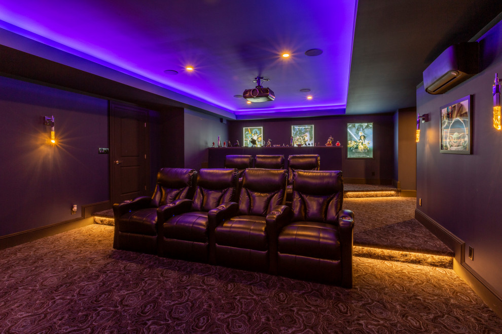 Expansive transitional open concept home theatre in New York with blue walls, carpet, a projector screen and blue floor.