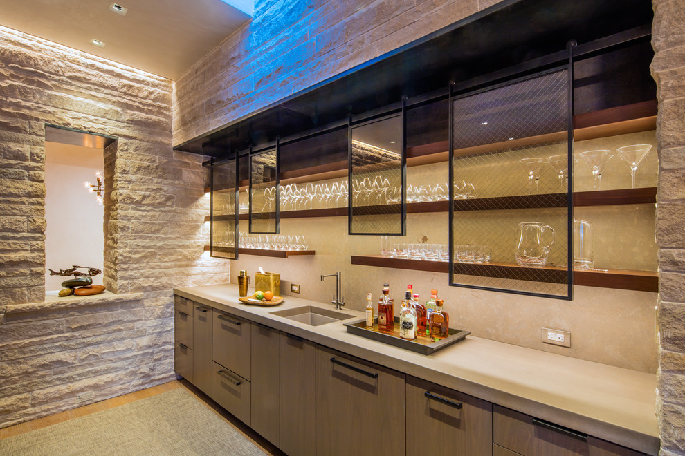 Transitional single-wall wet bar in Denver with an undermount sink, flat-panel cabinets, light wood cabinets, beige splashback and light hardwood floors.