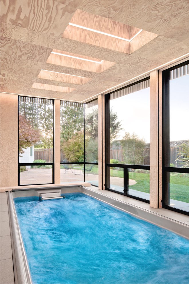 Inspiration for a small modern indoor rectangular pool in San Francisco with a pool house.