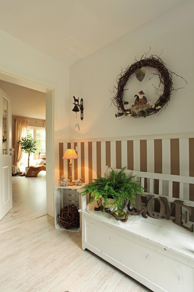 Design ideas for a country hallway in Other with white walls and light hardwood floors.