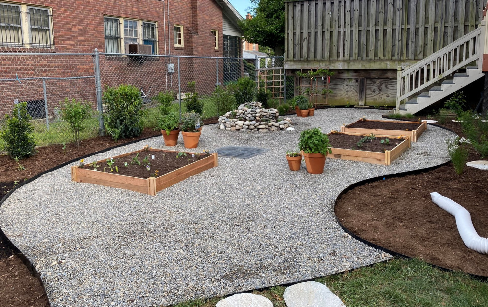 Photo of a mid-sized contemporary backyard full sun xeriscape for spring in DC Metro with a vegetable garden and gravel.