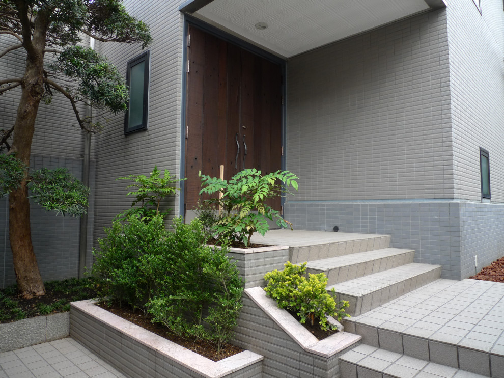 Inspiration for a mid-sized eclectic front door in Tokyo with beige walls, ceramic floors, a double front door, a dark wood front door, beige floor, timber and panelled walls.