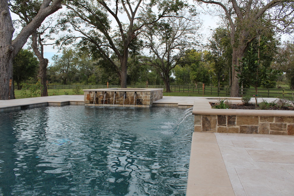Large transitional backyard stone and rectangular lap hot tub photo in Houston