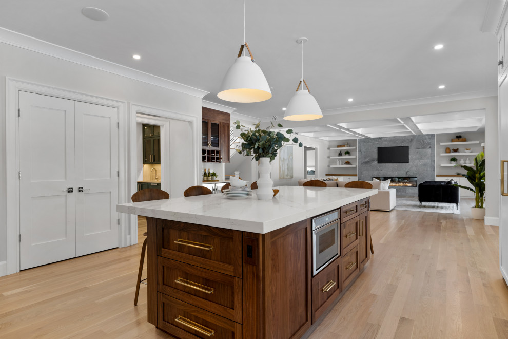 Inspiration for a huge transitional light wood floor, brown floor and coffered ceiling open concept kitchen remodel in Boston with an undermount sink, shaker cabinets, medium tone wood cabinets, quartz countertops, white backsplash, quartz backsplash, stainless steel appliances, an island and white countertops