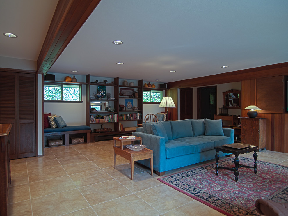 Photo of a large transitional enclosed family room in Seattle with white walls, porcelain floors, a concealed tv, beige floor and a library.