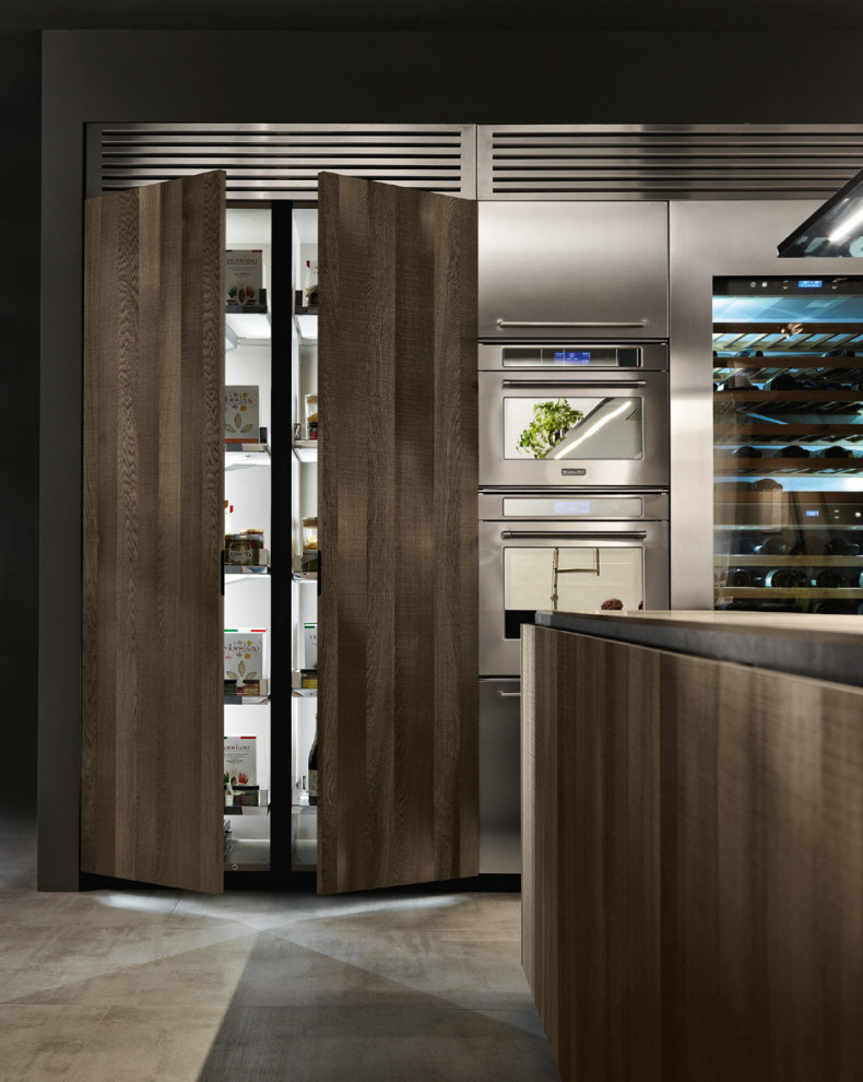 Large modern l-shaped kitchen/diner in Los Angeles with a triple-bowl sink, glass-front cabinets, medium wood cabinets, wood worktops, concrete flooring, an island and brown worktops.