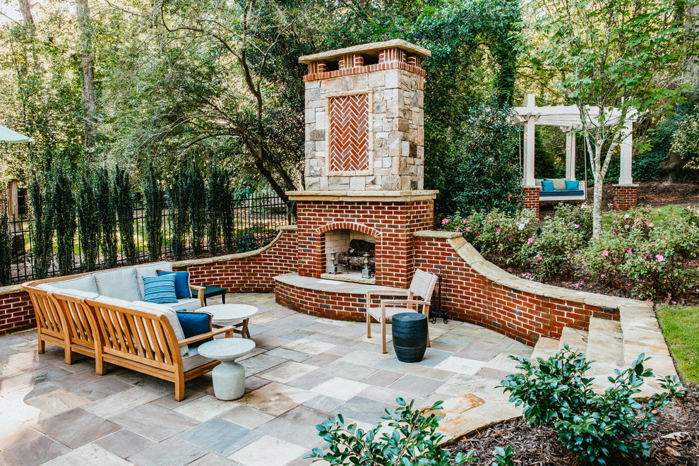 Traditional patio in Atlanta with with fireplace, tile and no cover.