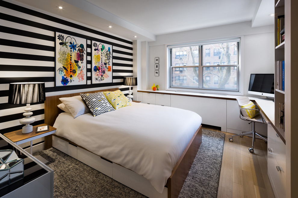 Inspiration for a contemporary guest bedroom in New York with multi-coloured walls and light hardwood floors.