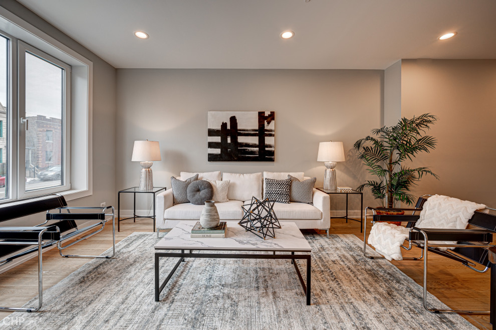 Inspiration for a contemporary open concept family room in Chicago with grey walls and light hardwood floors.