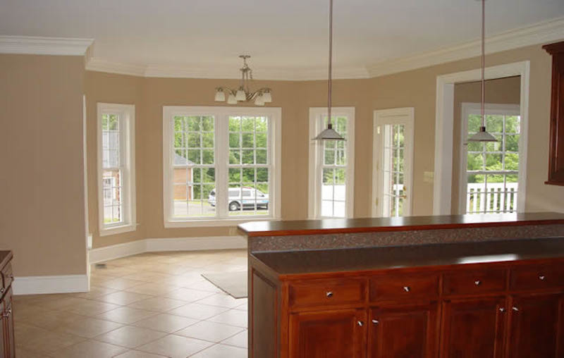 Kitchen - large ceramic tile kitchen idea with recessed-panel cabinets and dark wood cabinets
