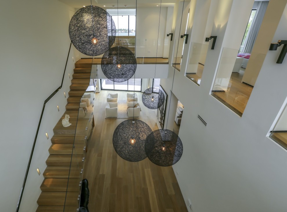 This is an example of a contemporary entryway in New York with light hardwood floors.