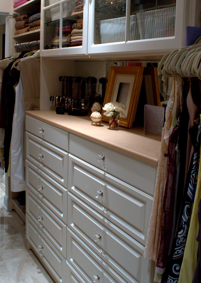 Large traditional gender-neutral walk-in wardrobe in Philadelphia with raised-panel cabinets and beige cabinets.