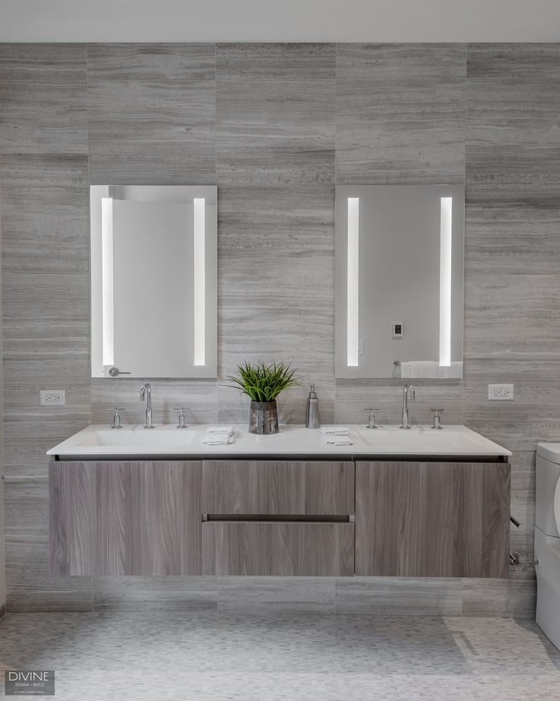This is an example of a large contemporary 3/4 bathroom in Boston with flat-panel cabinets, light wood cabinets, an open shower, a two-piece toilet, gray tile, ceramic tile, grey walls, ceramic floors, an integrated sink, engineered quartz benchtops, grey floor and an open shower.