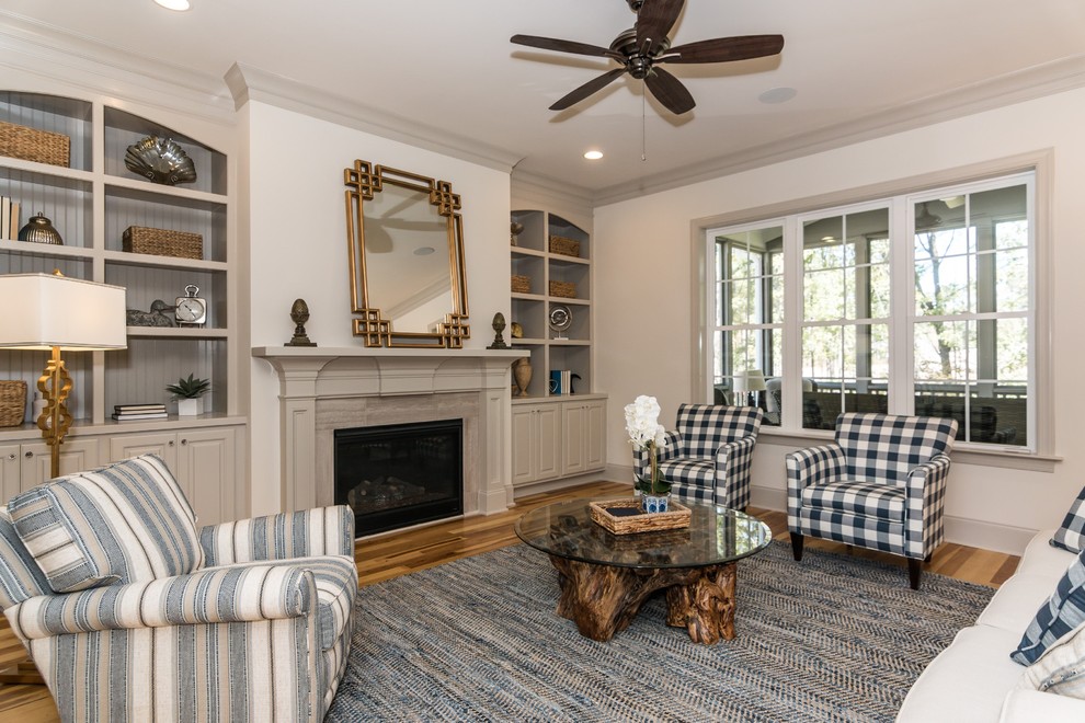 Inspiration for a mid-sized traditional formal open concept living room in Raleigh with no tv, white walls, light hardwood floors, a standard fireplace and a stone fireplace surround.